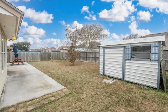 view of yard with a shed and a patio area