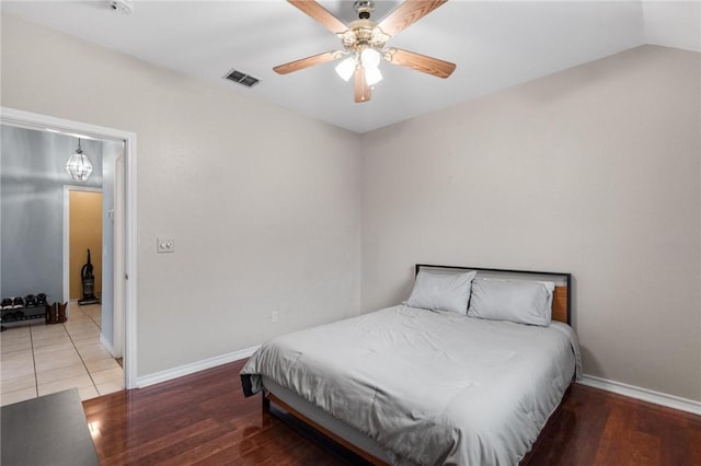 bedroom featuring wood-type flooring, lofted ceiling, and ceiling fan