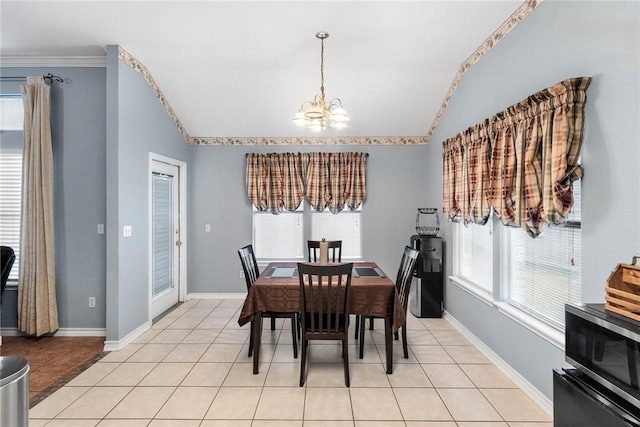 dining space with a chandelier, vaulted ceiling, and light tile patterned floors