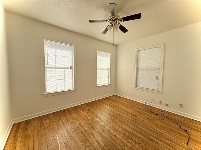 empty room featuring ceiling fan and wood-type flooring