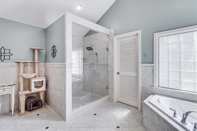 209 Jackson Pl, Corpus Christi, TX 78411 - bathroom featuring tile walls, vaulted ceiling, plenty of natural light, a garden tub, and a stall shower