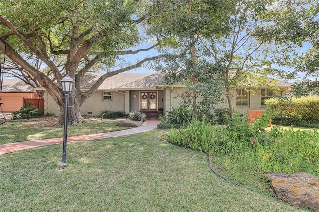 209 Jackson Pl, Corpus Christi, TX 78411 - view of front of home with french doors and a front yard