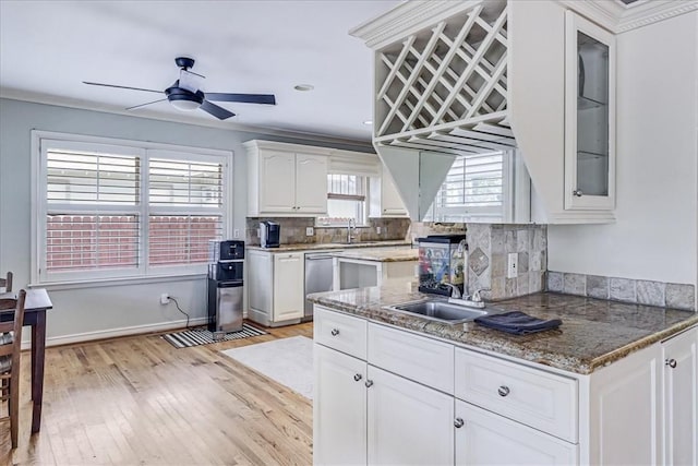 209 Jackson Pl, Corpus Christi, TX 78411 - kitchen with a ceiling fan, stainless steel dishwasher, white cabinets, light wood-style flooring, and glass insert cabinets