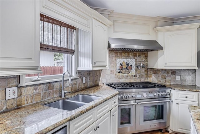 209 Jackson Pl, Corpus Christi, TX 78411 - kitchen with double oven range, wall chimney exhaust hood, tasteful backsplash, and white cabinets