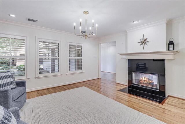 209 Jackson Pl, Corpus Christi, TX 78411 - living room with a multi sided fireplace, a chandelier, wood finished floors, crown molding, and recessed lighting