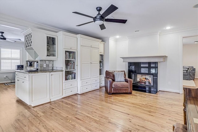 209 Jackson Pl, Corpus Christi, TX 78411 - living area featuring a ceiling fan, ornamental molding, light wood-style floors, a multi sided fireplace, and recessed lighting