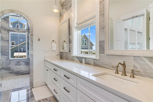 320 Coastline Dr, Port Aransas, TX 78373 - bathroom with double vanity, backsplash, and a stall shower