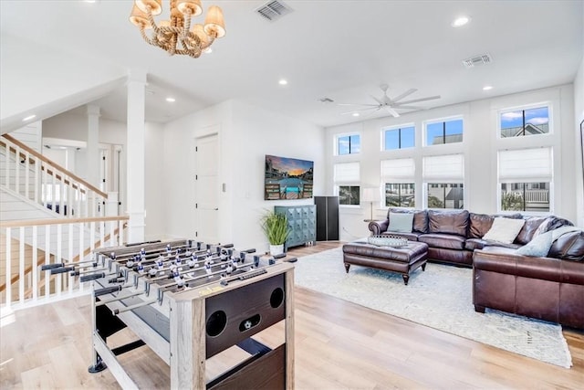 320 Coastline Dr, Port Aransas, TX 78373 - rec room with ceiling fan, decorative columns, light wood-type flooring, recessed lighting, and a chandelier