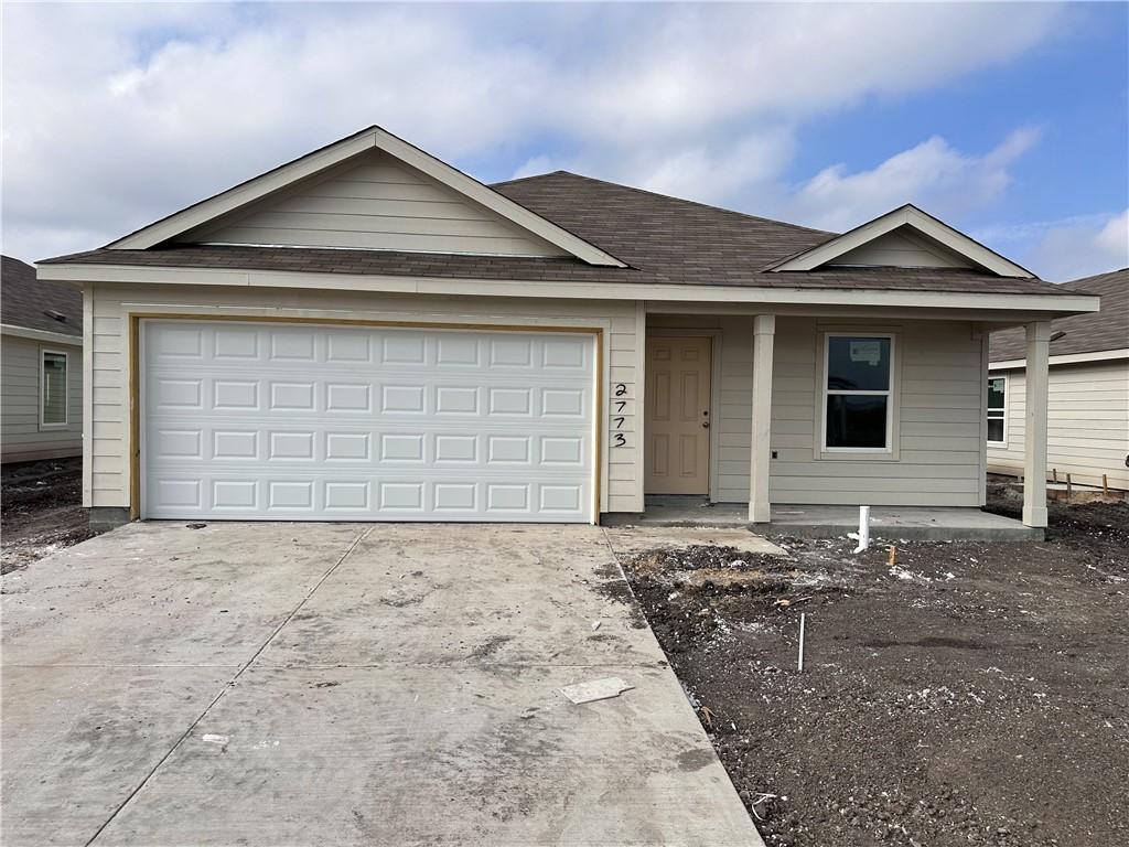 ranch-style house with covered porch and a garage