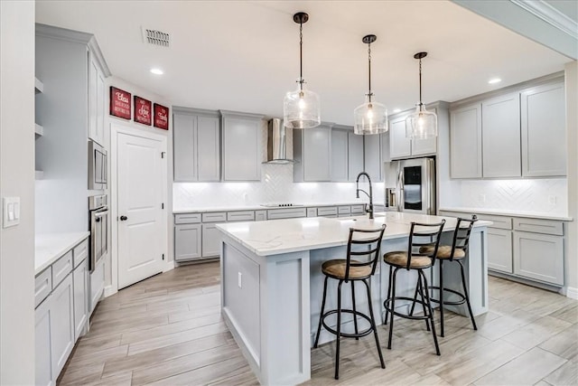 4102 Fold Ln, Corpus Christi, TX 78414 - kitchen with stainless steel appliances, wall chimney exhaust hood, gray cabinetry, and recessed lighting