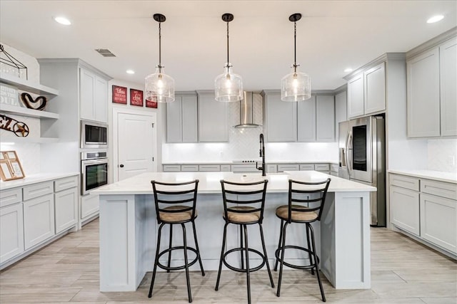 4102 Fold Ln, Corpus Christi, TX 78414 - kitchen with stainless steel appliances, wall chimney range hood, open shelves, a kitchen island with sink, and tasteful backsplash
