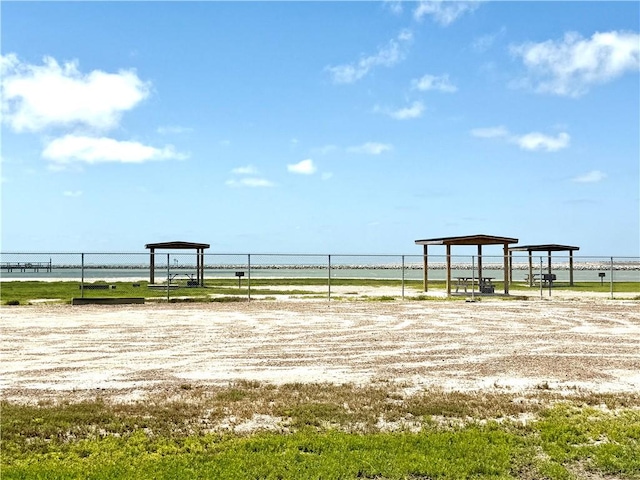 607 Huisache Lane, Ingleside On The Bay, TX 78362 - view of yard with a detached carport and a water view