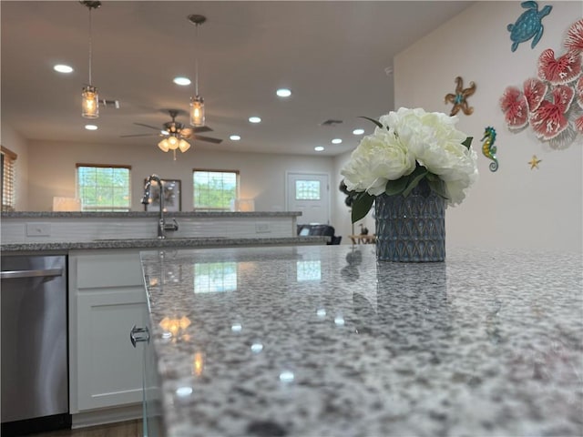 607 Huisache Lane, Ingleside On The Bay, TX 78362 - kitchen with stainless steel dishwasher, recessed lighting, hanging light fixtures, light stone counters, and a ceiling fan