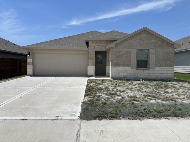 1109 Carnaby St, Corpus Christi, TX 78415 - ranch-style home featuring brick siding, a garage, concrete driveway, and a shingled roof