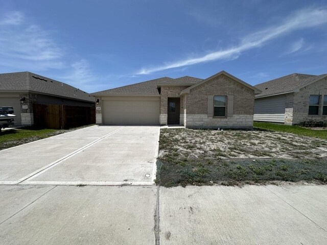 1109 Carnaby St, Corpus Christi, TX 78415 - view of front of home with concrete driveway, a garage, and brick siding