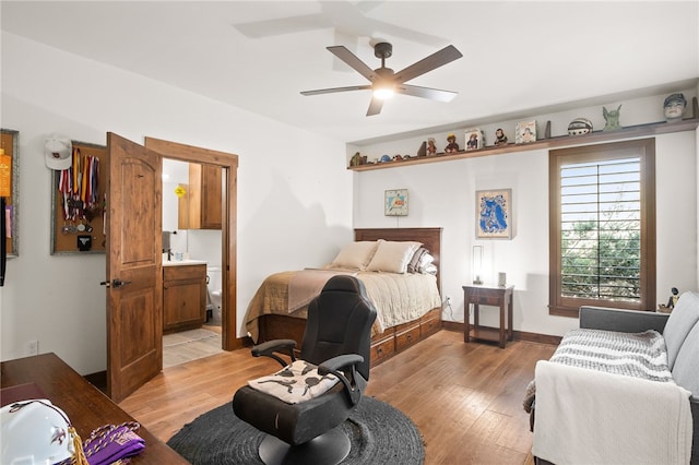 5502 E Riverview Dr, Corpus Christi, TX 78410 - bedroom with light wood finished floors, ensuite bathroom, and ceiling fan
