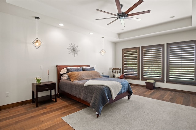5502 E Riverview Dr, Corpus Christi, TX 78410 - bedroom with wood finished floors, recessed lighting, a tray ceiling, and a ceiling fan
