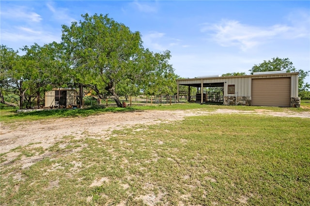 5502 E Riverview Dr, Corpus Christi, TX 78410 - view of yard featuring an outbuilding, a garage, and driveway