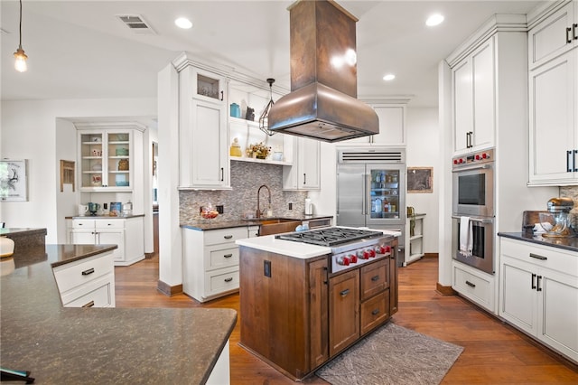 5502 E Riverview Dr, Corpus Christi, TX 78410 - kitchen featuring stainless steel appliances, island exhaust hood, a kitchen island, dark wood-type flooring, and recessed lighting