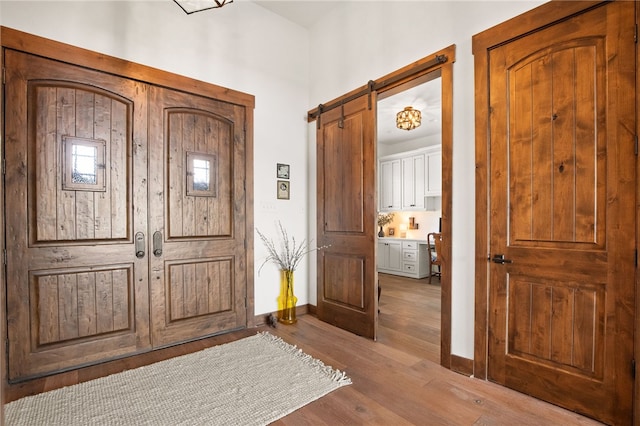 5502 E Riverview Dr, Corpus Christi, TX 78410 - entrance foyer featuring a barn door and wood finished floors