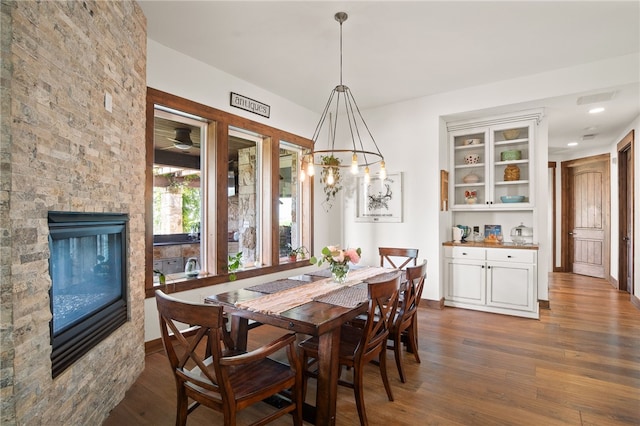 5502 E Riverview Dr, Corpus Christi, TX 78410 - dining space featuring dark wood finished floors, a stone fireplace, and recessed lighting