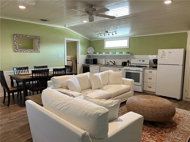 living room with dark hardwood / wood-style flooring, vaulted ceiling, ceiling fan, crown molding, and wine cooler