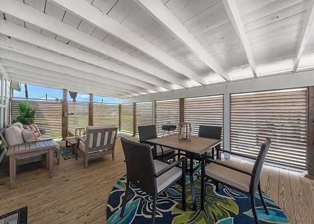 sunroom featuring beamed ceiling and wooden ceiling