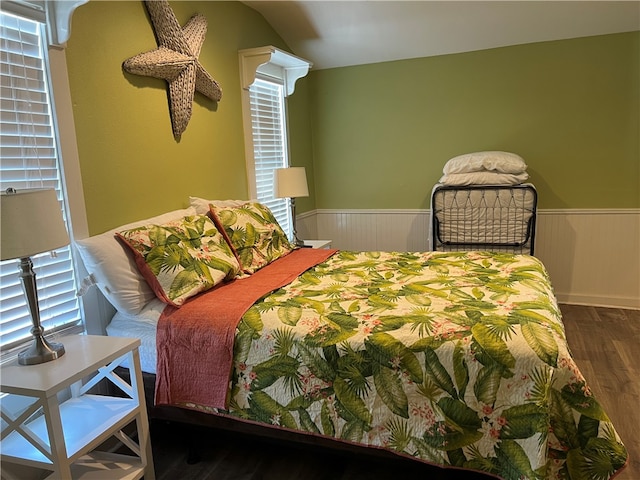 bedroom with dark wood-type flooring and lofted ceiling