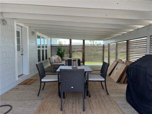 sunroom featuring a wealth of natural light and lofted ceiling