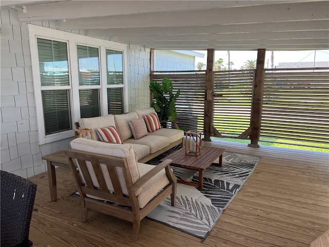 sunroom / solarium featuring a wealth of natural light and beam ceiling