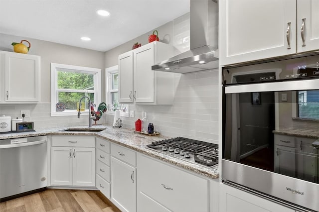 934 Cunningham St, Corpus Christi, TX 78411 - kitchen featuring stainless steel appliances, wall chimney exhaust hood, white cabinetry, backsplash, and recessed lighting