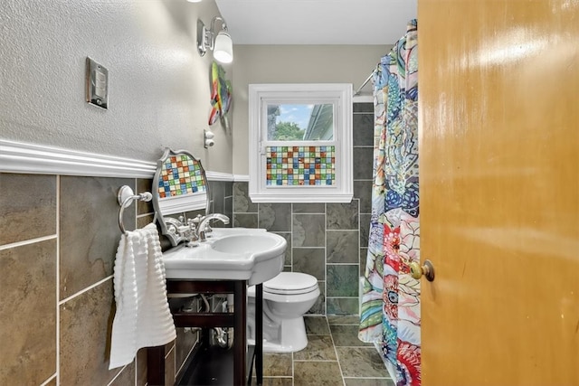 934 Cunningham St, Corpus Christi, TX 78411 - bathroom with tile walls, vanity, curtained shower, and a wainscoted wall