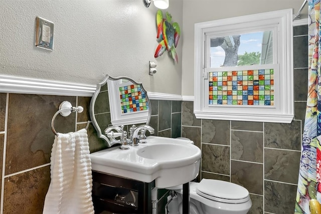 934 Cunningham St, Corpus Christi, TX 78411 - full bathroom with tile walls and a wainscoted wall