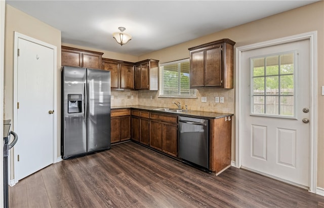 kitchen featuring dark wood finished floors, a healthy amount of sunlight, stainless steel appliances, and a sink