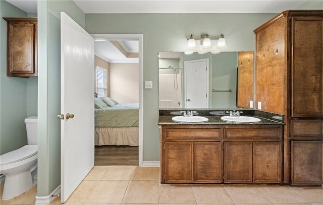 full bathroom featuring tile patterned flooring, connected bathroom, toilet, and a sink