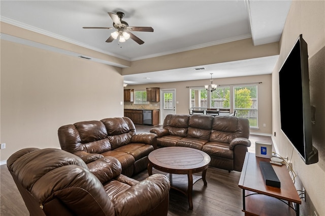 living room featuring ceiling fan with notable chandelier, visible vents, ornamental molding, and wood-type flooring