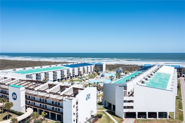 birds eye view of property featuring a water view and a beach view