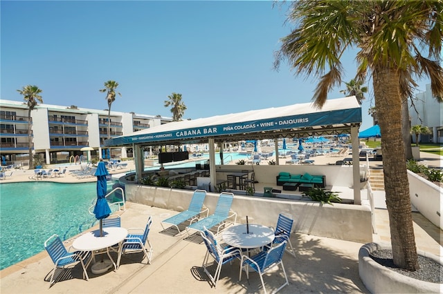 view of community featuring a swimming pool and a water view