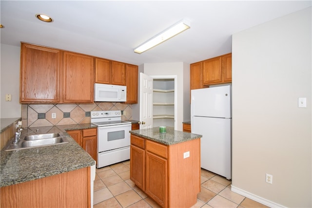 kitchen with a center island, white appliances, sink, decorative backsplash, and light tile patterned floors