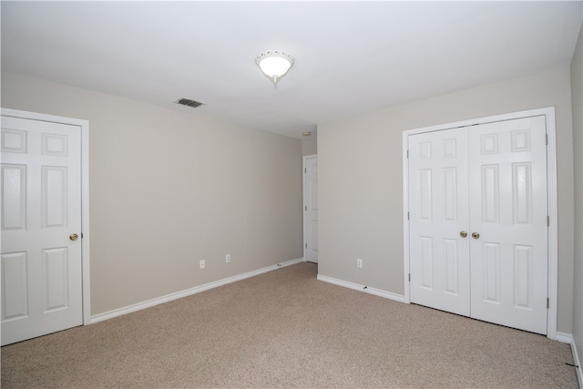 unfurnished bedroom featuring light colored carpet