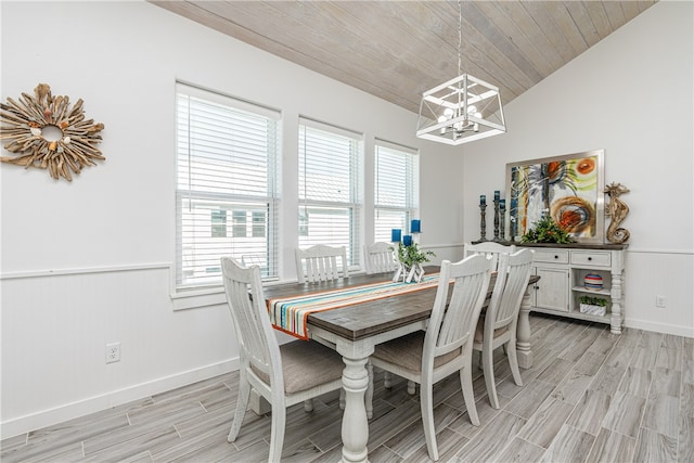 dining area featuring a chandelier, light wood-type flooring, vaulted ceiling, and wood ceiling