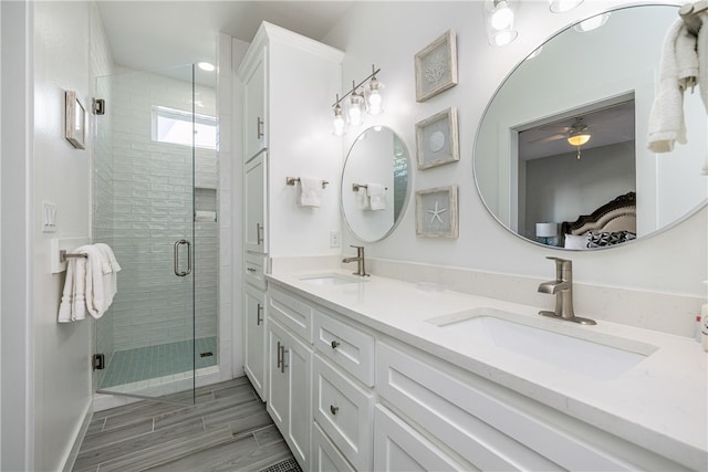 bathroom featuring vanity and an enclosed shower