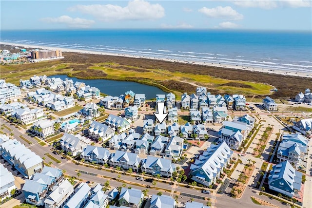 bird's eye view with a view of the beach, a water view, and a residential view