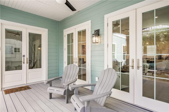 wooden terrace featuring french doors and ceiling fan