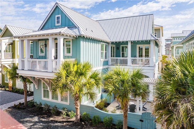 view of front of home featuring board and batten siding, a standing seam roof, metal roof, and a porch