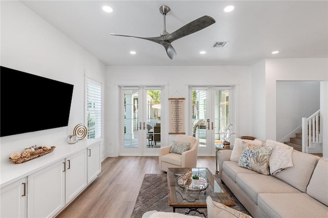 living area featuring visible vents, ceiling fan, french doors, light wood-style floors, and recessed lighting