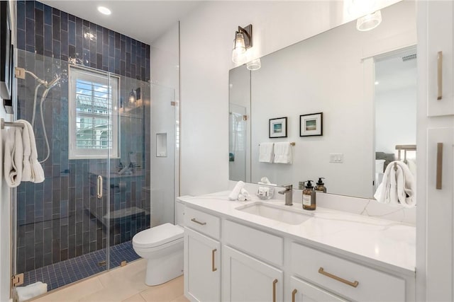 full bathroom featuring tile patterned flooring, toilet, vanity, and a shower stall