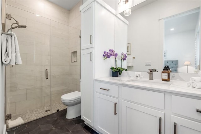 full bath featuring toilet, tile patterned floors, a shower stall, and vanity