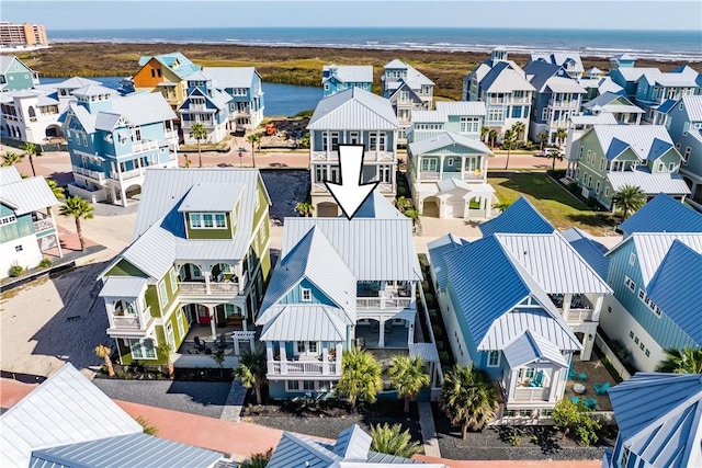 drone / aerial view featuring a water view and a residential view