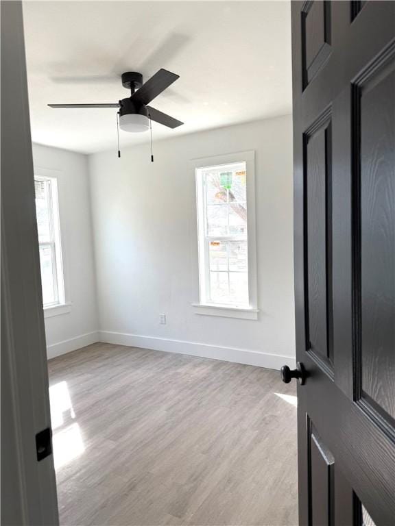 unfurnished room featuring ceiling fan and light hardwood / wood-style floors